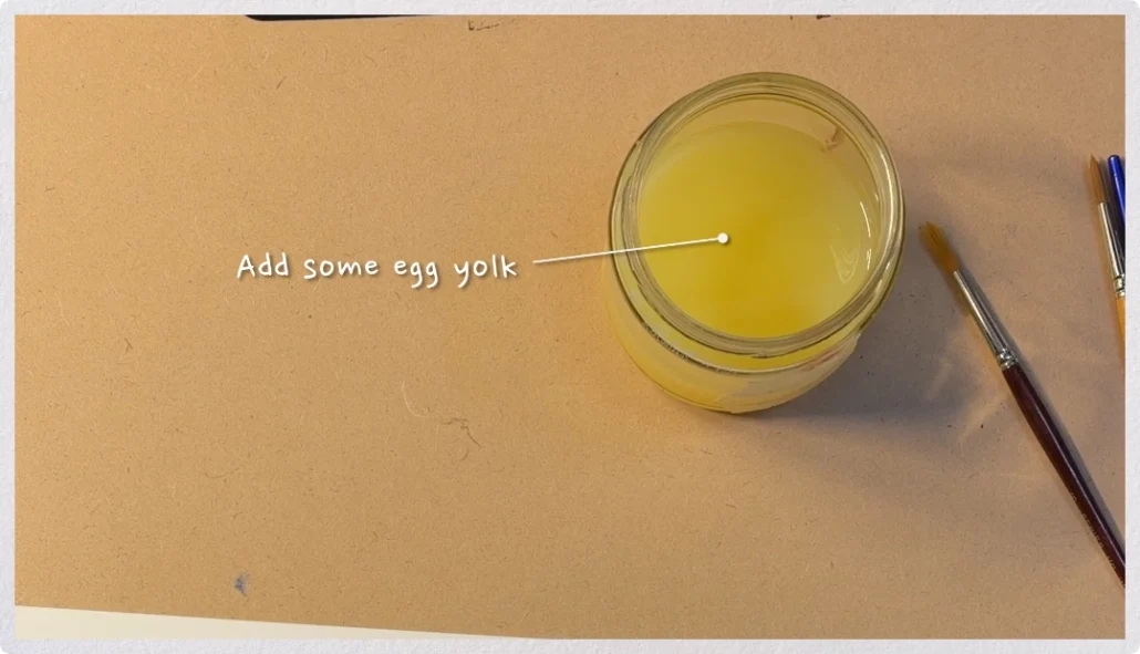 A jar of water with a small amount of egg yolk added to help gouache behave more like oil paint, improving brushstroke retention and handling.