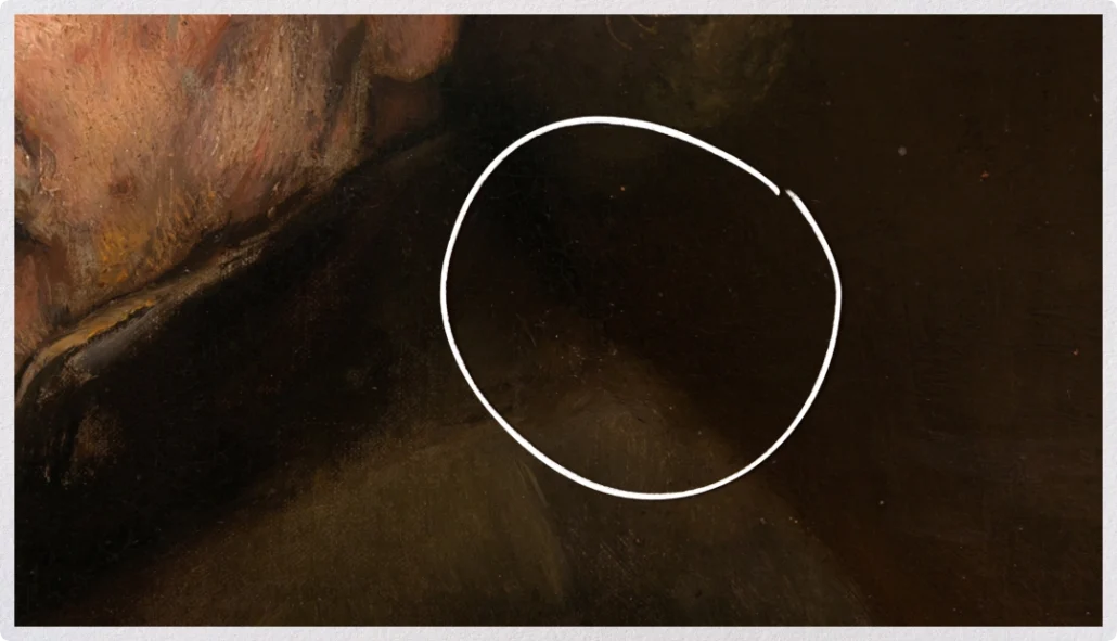Close-up of a Rembrandt painting with a white circle highlighting a soft edge between dark values.